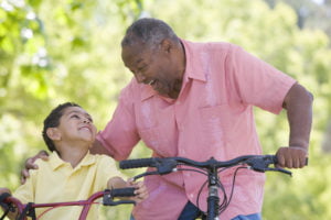 Grandfather and grandson riding bikes