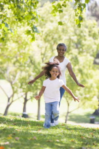 Grandmother and granddaughter running in the park