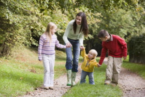 Mother and children walking in woods