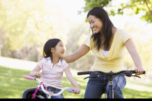 Mother and daughter riding bikes